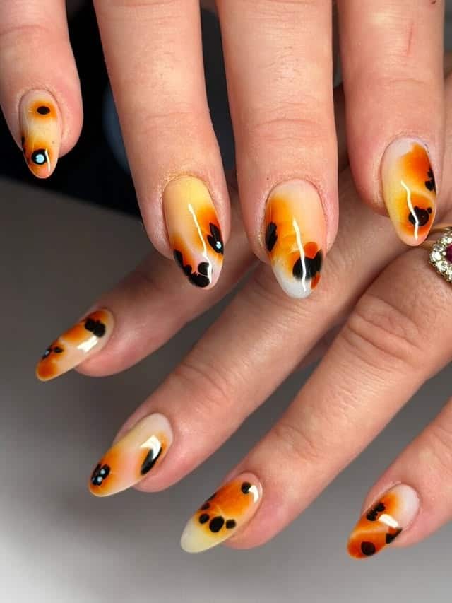21. Soft Gradient Almond Nails in Black and Orange - black and orange nail ideas