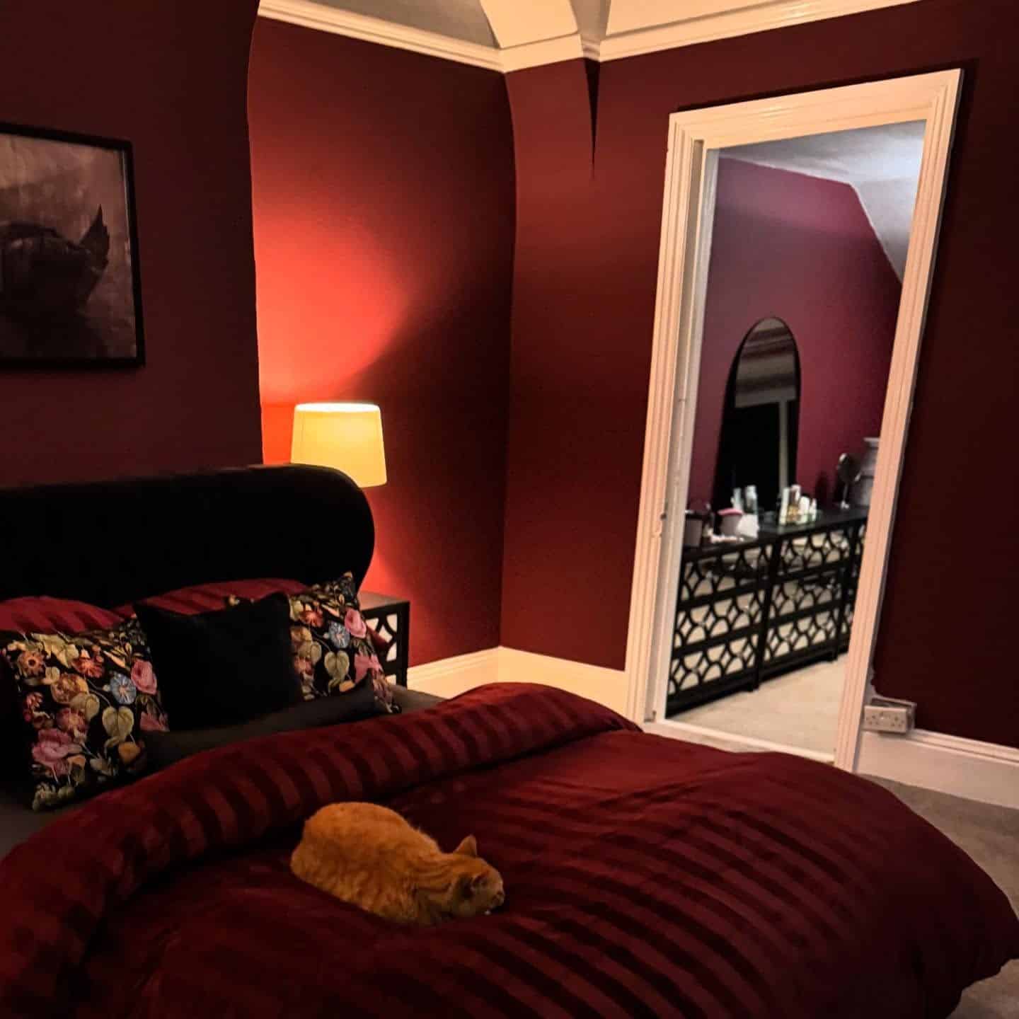12. Dark Red Bedroom with Classic Trim Details - red bedroom ideas