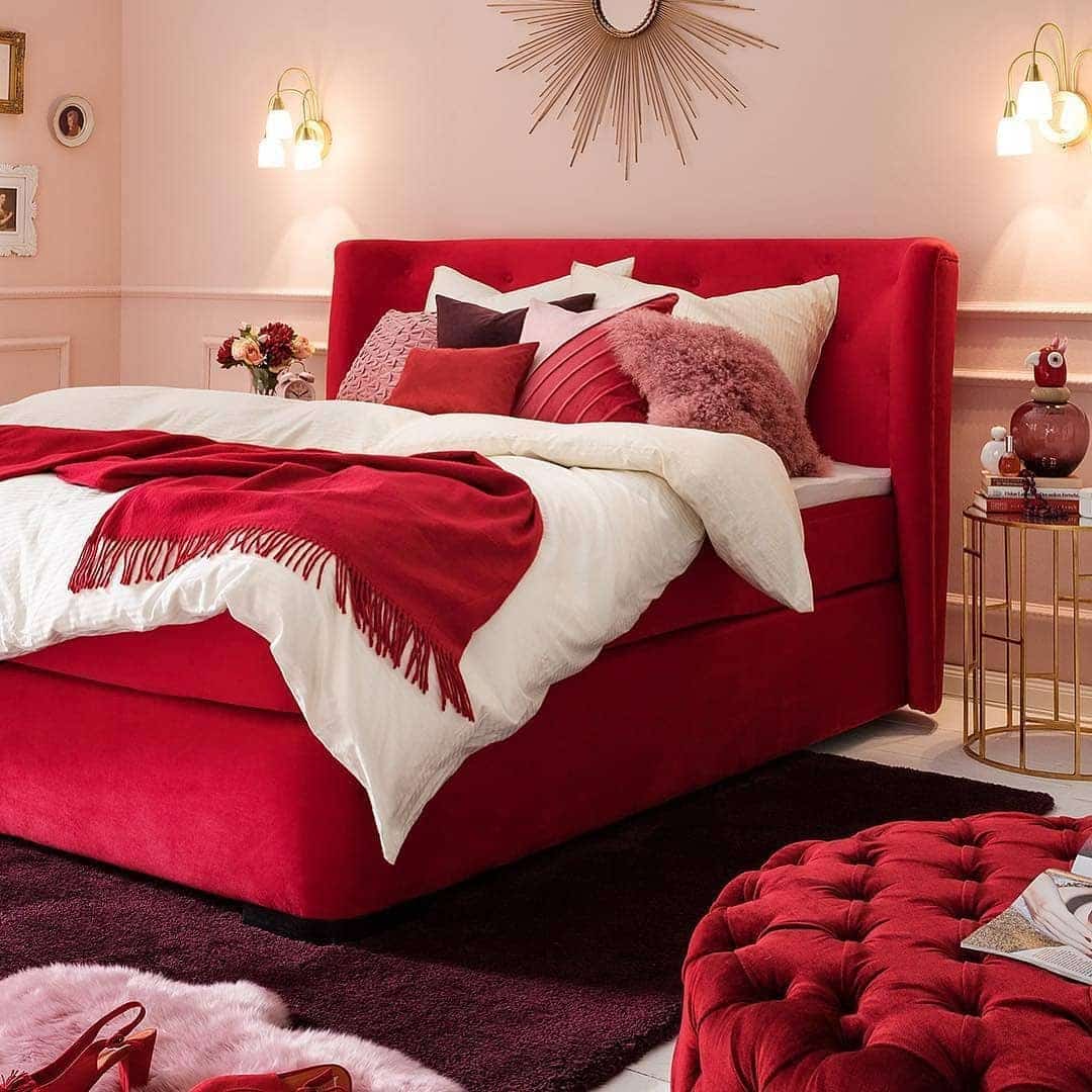 16. Soft Red Upholstered Bed with Layered Textiles - red bedroom ideas