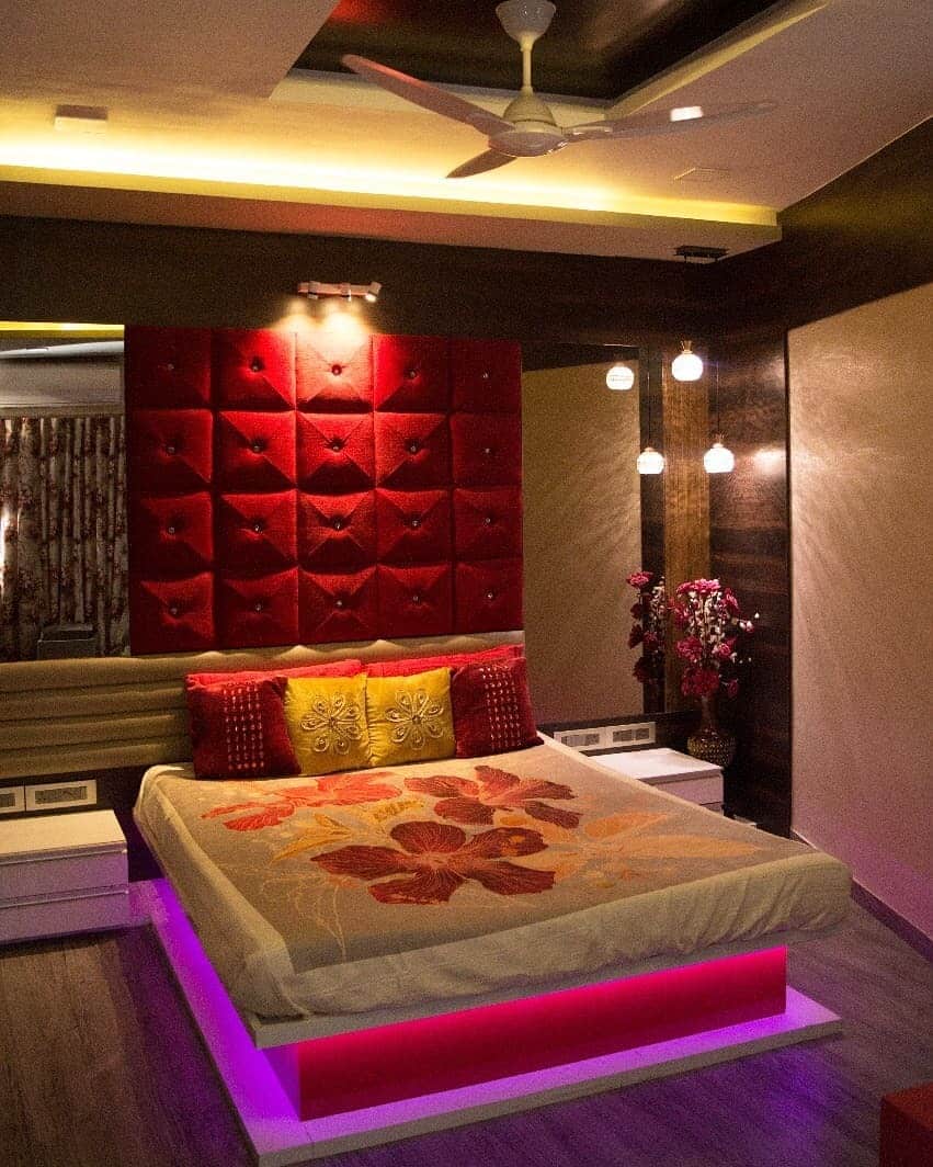 17. Contemporary Red Accent Bedroom with Ambient Lighting - red bedroom ideas