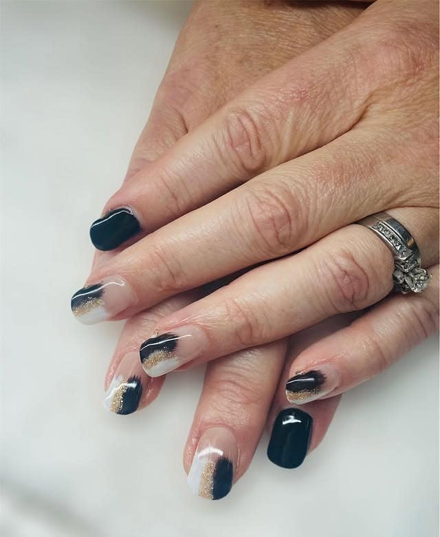1. Black French with Soft Gold Accents - black, white and gold nail ideas