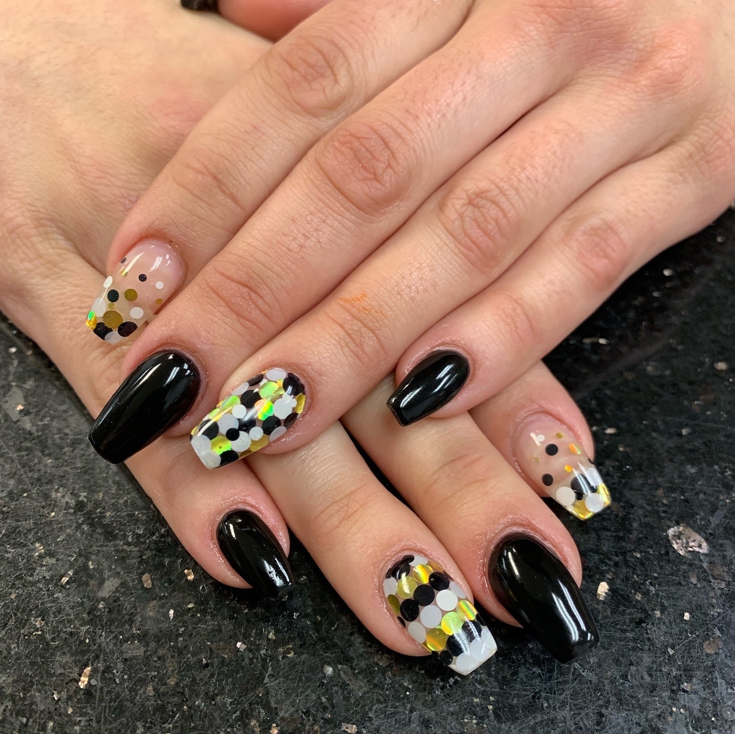 2. Black Gloss with Gold Confetti Overlay - black, white and gold nail ideas