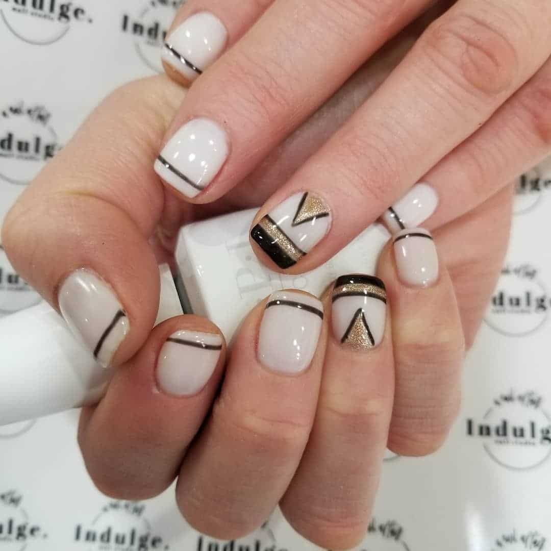 3. White Geometric Lines with Black and Gold Detail - black, white and gold nail ideas