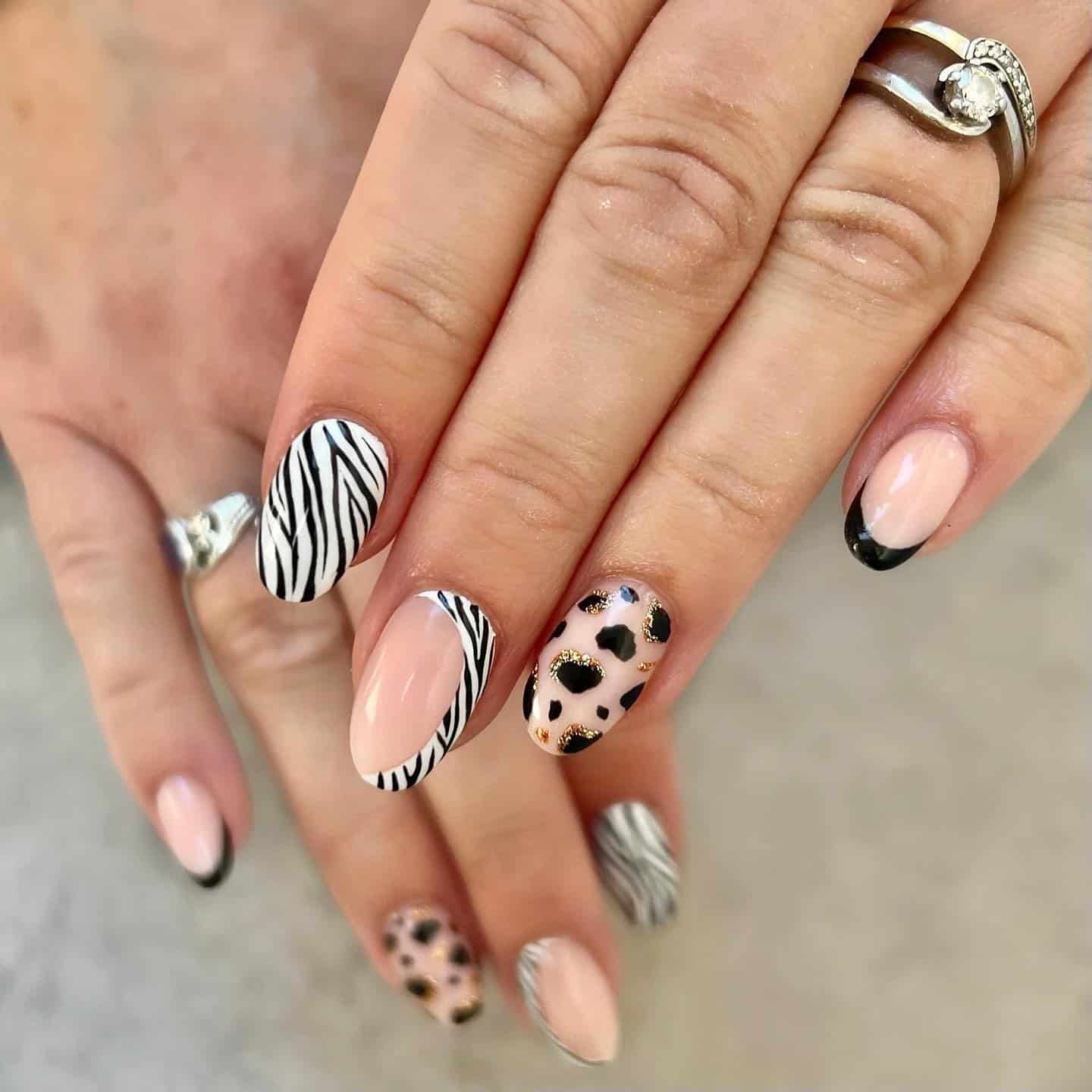 5. Zebra Print with Gold Foil Accents - black, white and gold nail ideas