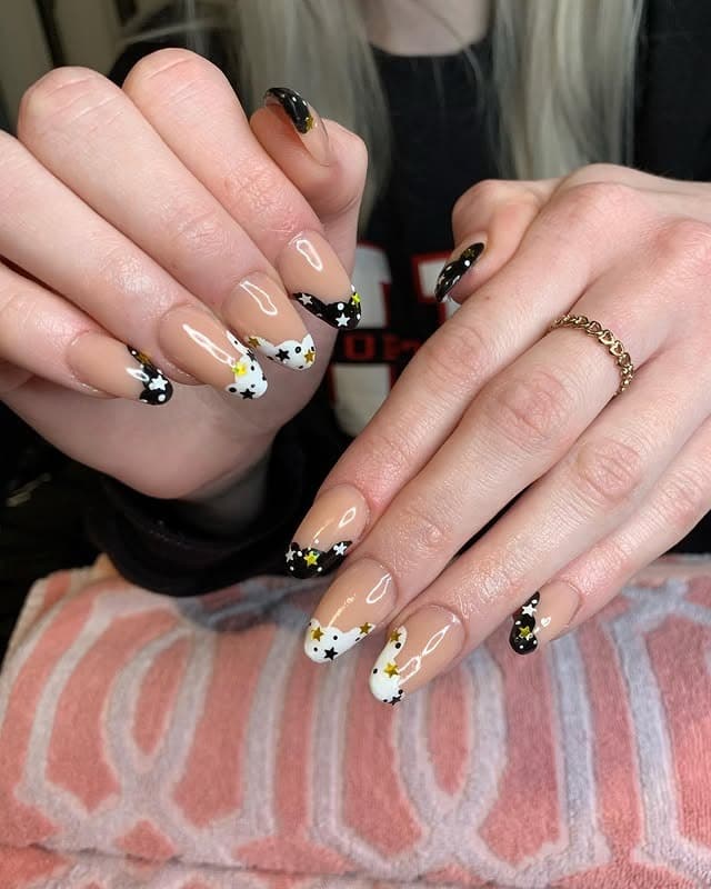 10. Nude Nails with Black Tips and Star Accents - black, white and gold nail ideas