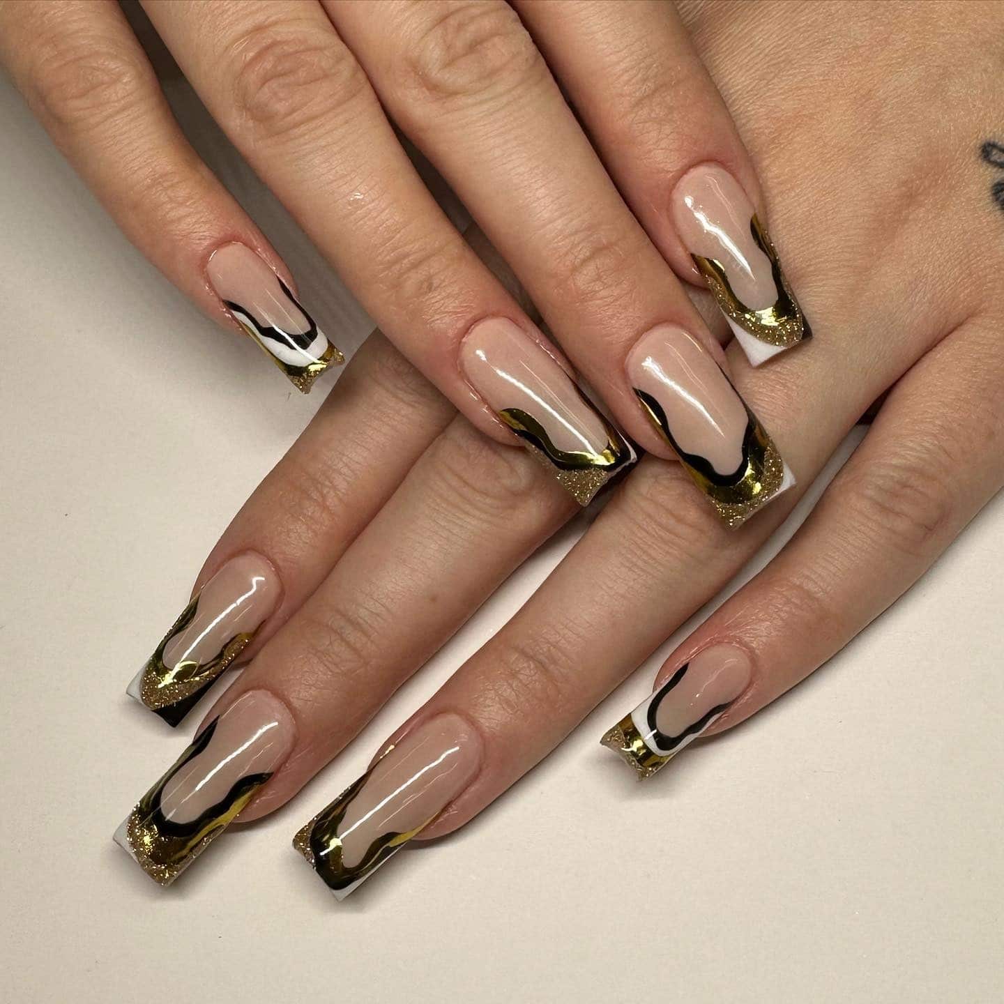 14. Nude Nails with Flowing Black and Gold Edges - black, white and gold nail ideas