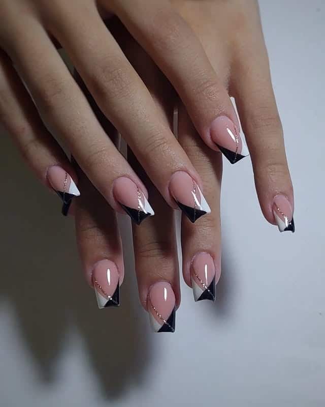 17. Geometric Black and White French with Gold Lines - black, white and gold nail ideas