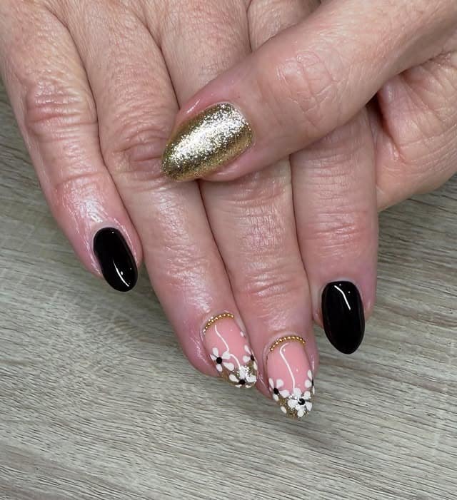 18. Black, Nude, and Gold Floral Accent Nails - black, white and gold nail ideas