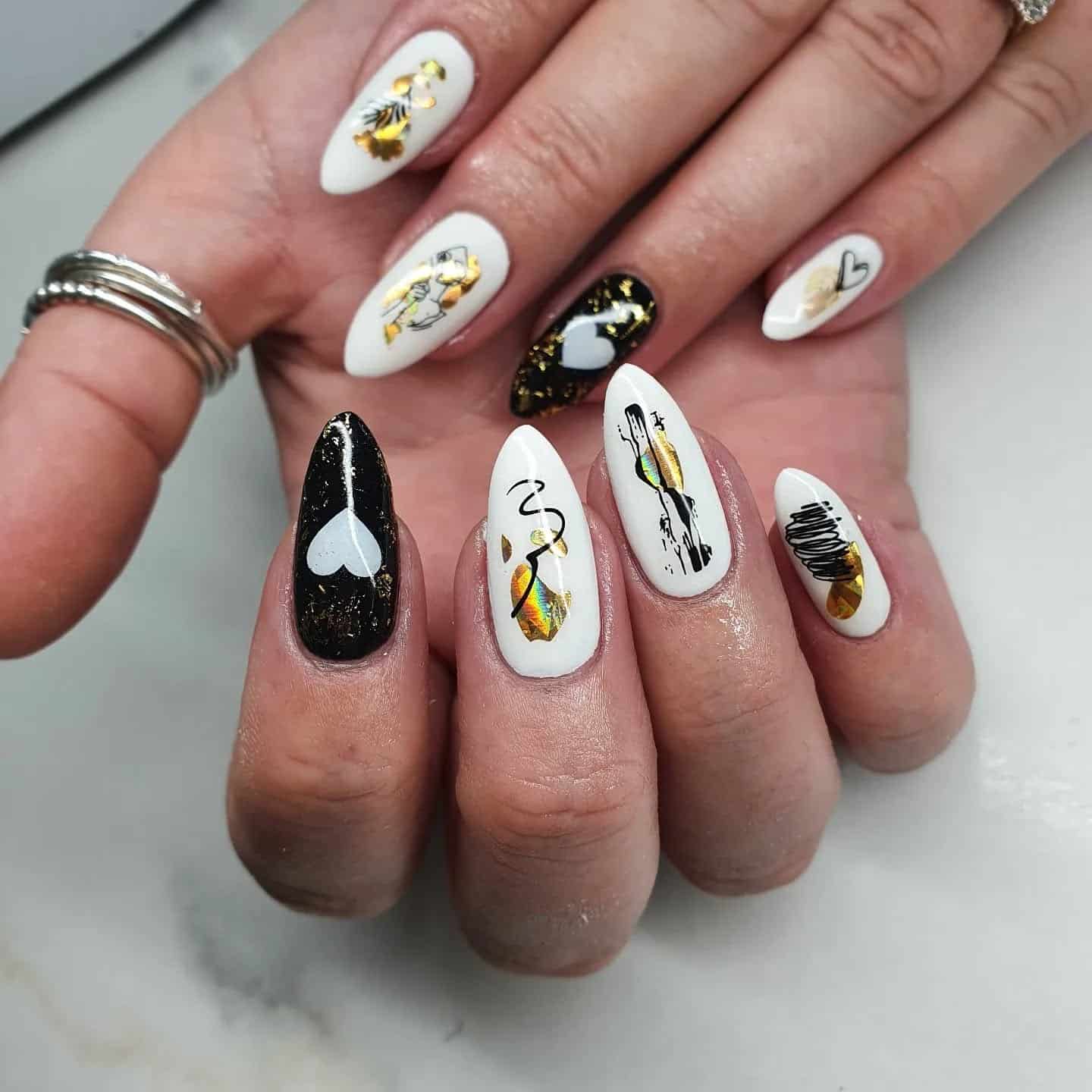 19. White and Black Graphic Art with Gold Foil Details - black, white and gold nail ideas