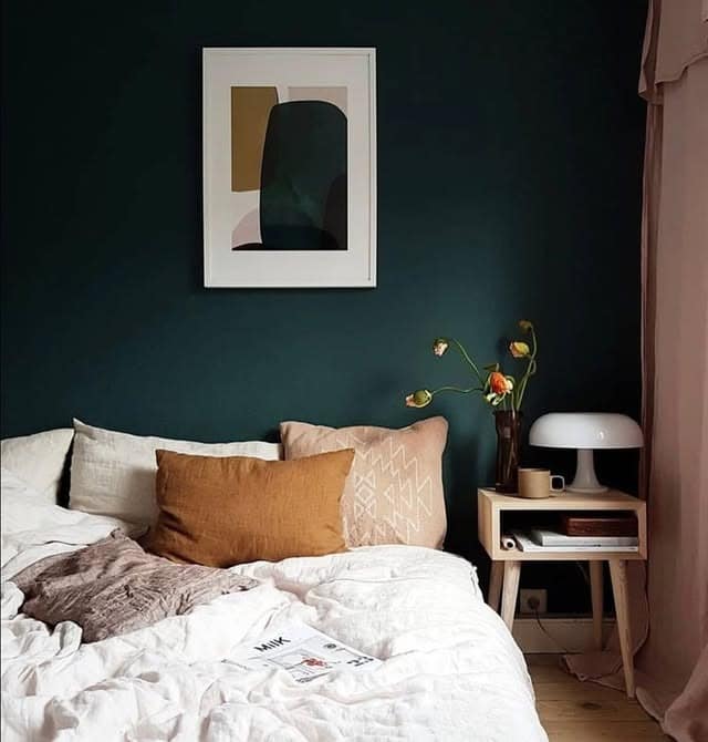 5. Moody Green Bedroom with Warm Blush Accents - dark green bedroom ideas