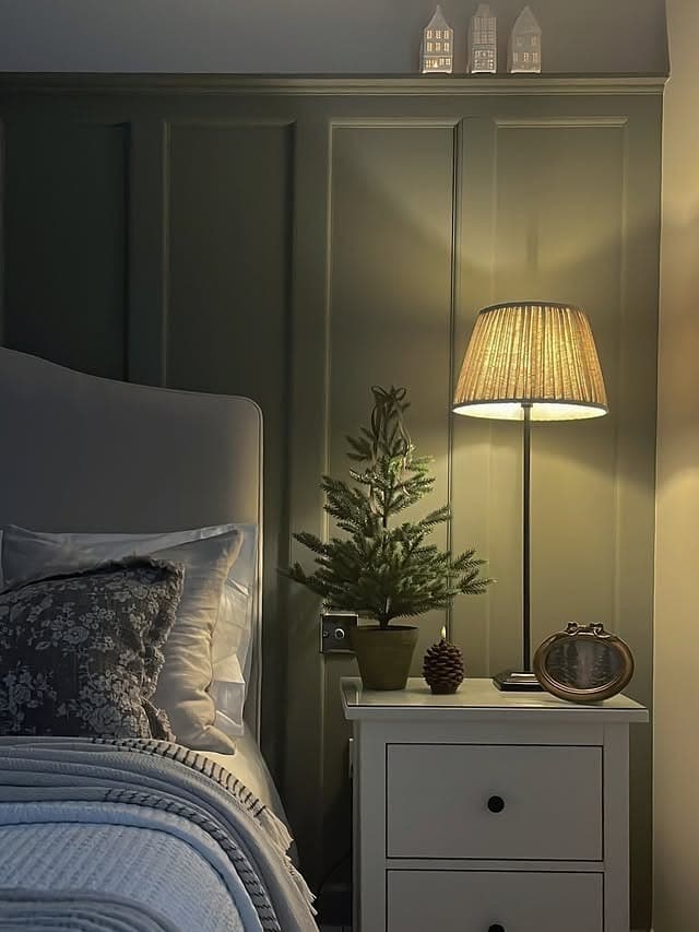 11. Classic Dark Green Paneling with Soft Lighting - dark green bedroom ideas