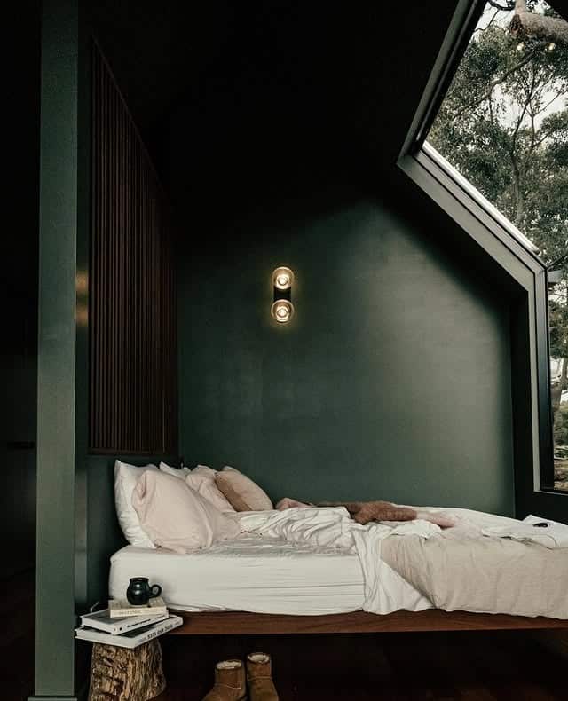 15. Attic-Style Dark Green Bedroom with Sloped Ceilings - dark green bedroom ideas