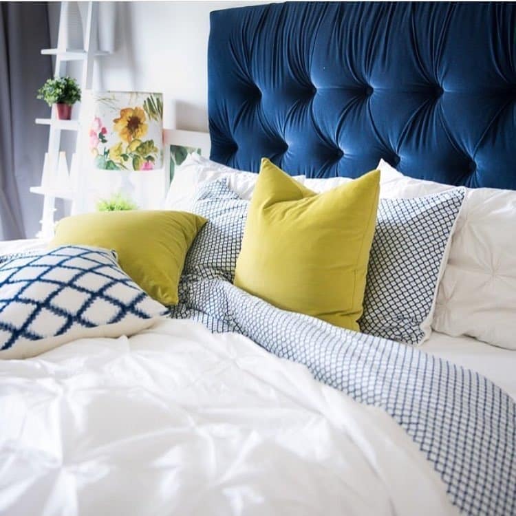11. Tufted Blue Headboard with Soft Yellow Pillows - yellow and blue bedroom ideas