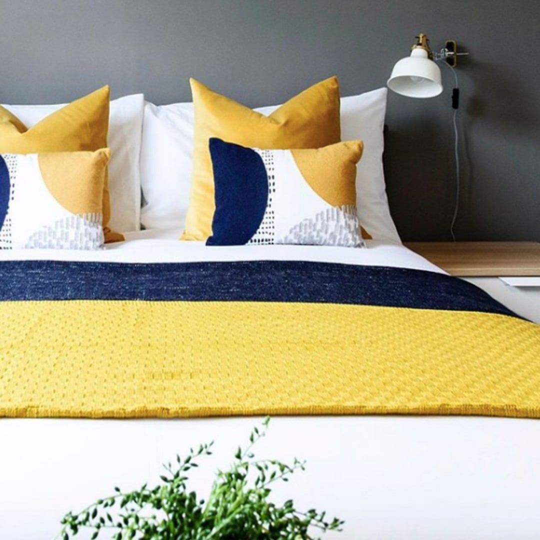 19. Modern Yellow and Blue Pillow Styling - yellow and blue bedroom ideas