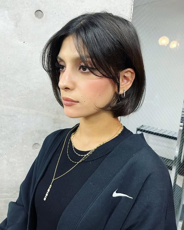 10. Sleek Jaw-Length Bob with Tapered Bangs in Natural Black - Bob Hairstyles with Bangs