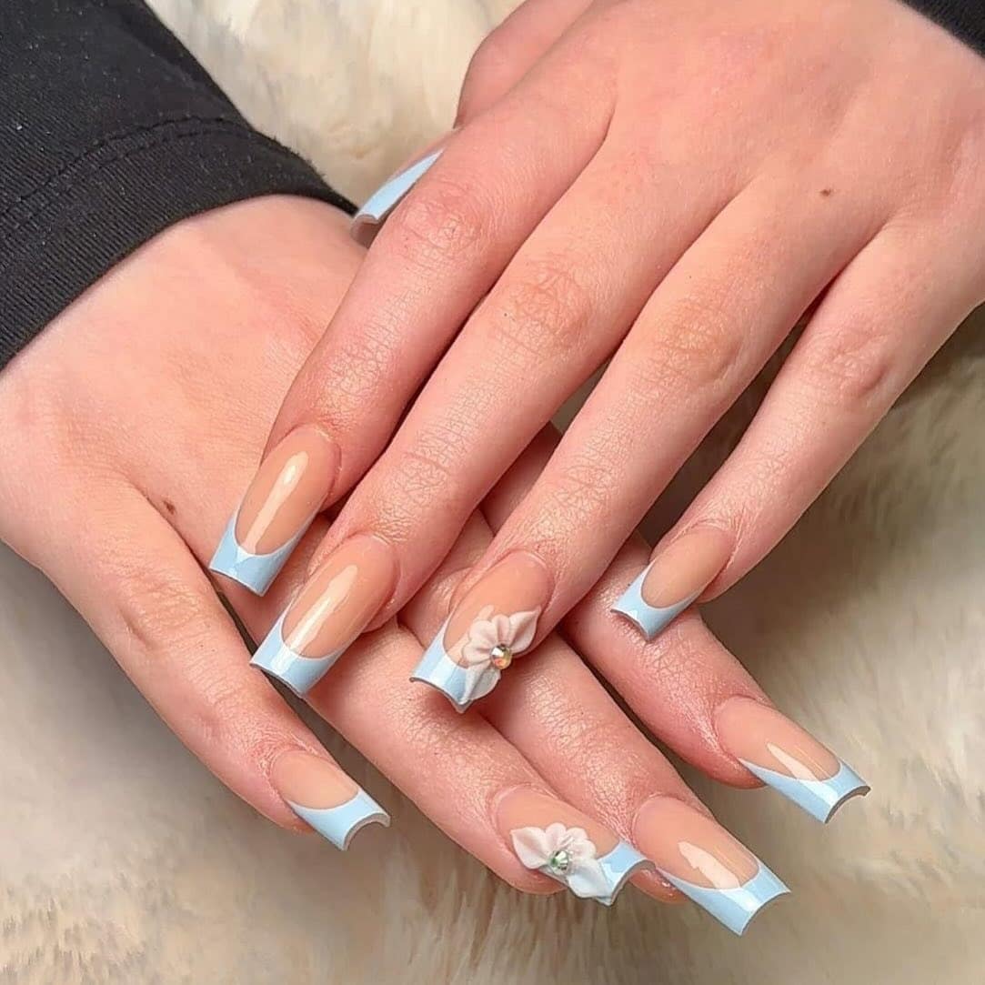 1. Baby Blue Sculpted French with 3D Floral Accent - blue tip nail ideas
