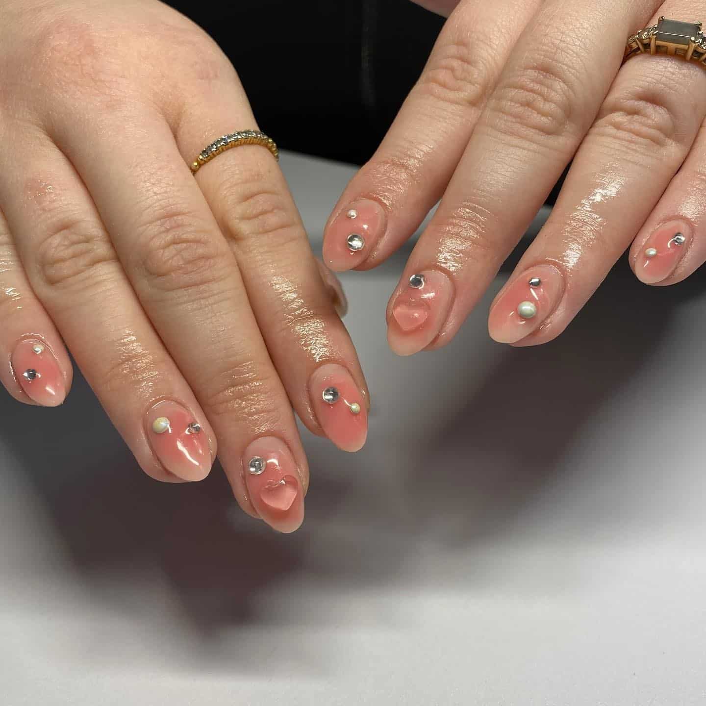 9. Glossy Nude Blush Almond Nails with Pearl and Crystal Accents - blush nail ideas