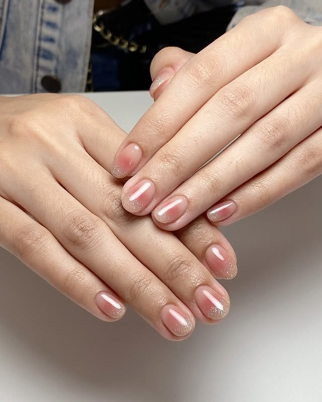 18. Sheer Nude Blush Short Nails with Micro Glitter - blush nail ideas