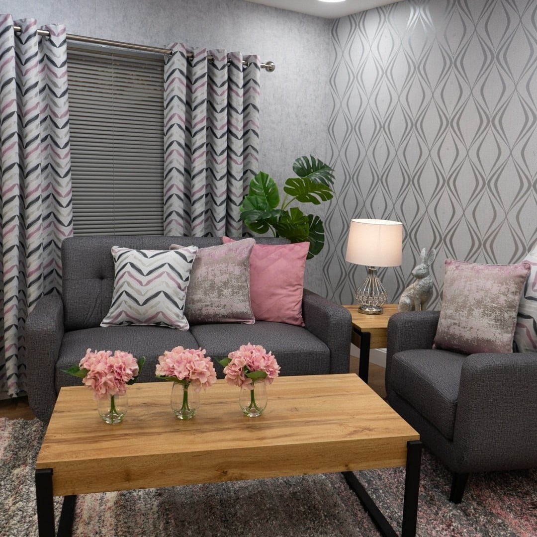 7. Patterned Grey Walls with Soft Pink Accessories - grey and pink living room ideas