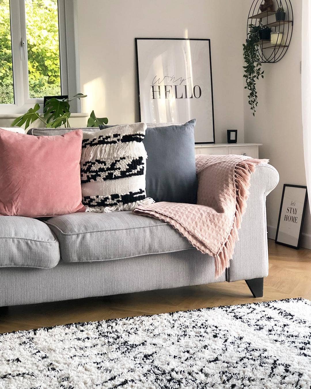 13. Casual Grey Sofa with Blush and Graphic Accents - grey and pink living room ideas