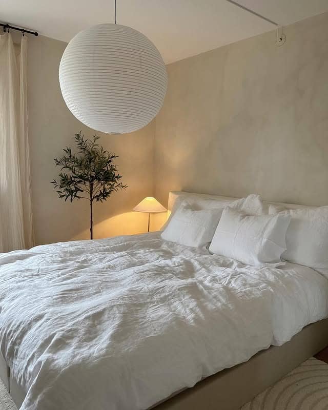 5. Creamy Minimalist Bedroom with Soft Ambient Lighting - scandinavian bedroom ideas