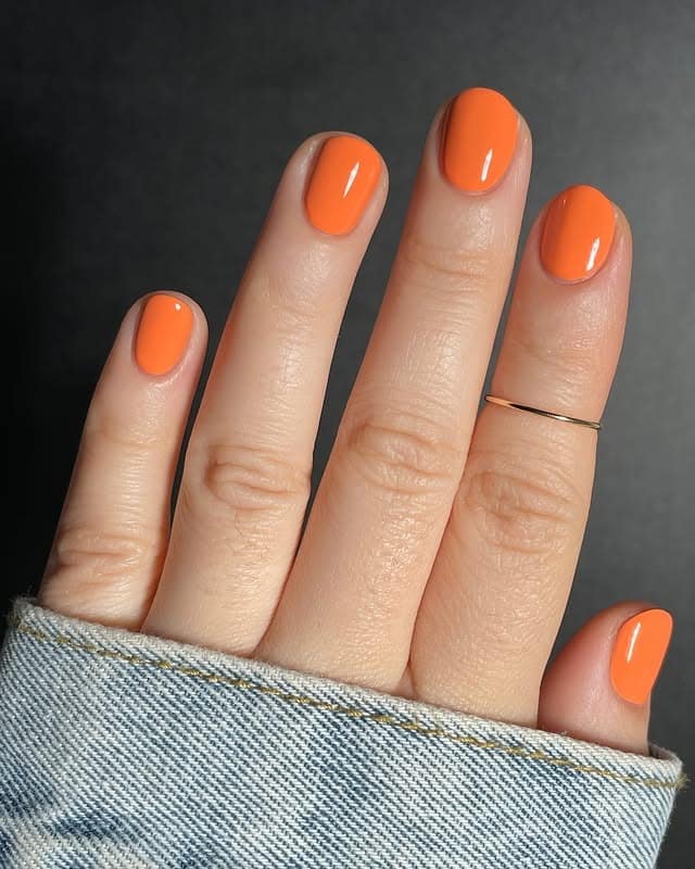 9. Short Natural Nails in Creamy Bright Orange - bright orange nail ideas