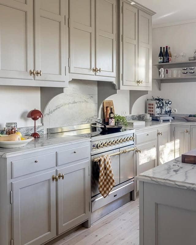 15. Pale Gray Classic Kitchen with Arched Marble Backsplash - classic kitchen ideas