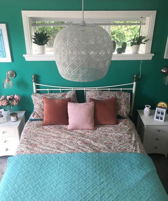 3. Deep Teal Walls with Warm Accent Pillows - turquoise bedroom ideas