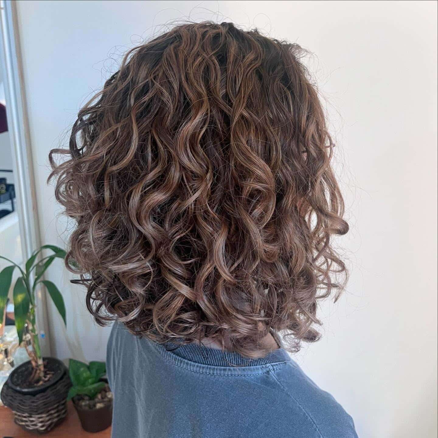 19. Shoulder-Grazing Curly Lob in Mocha Brown - Short Curly Hairstyles