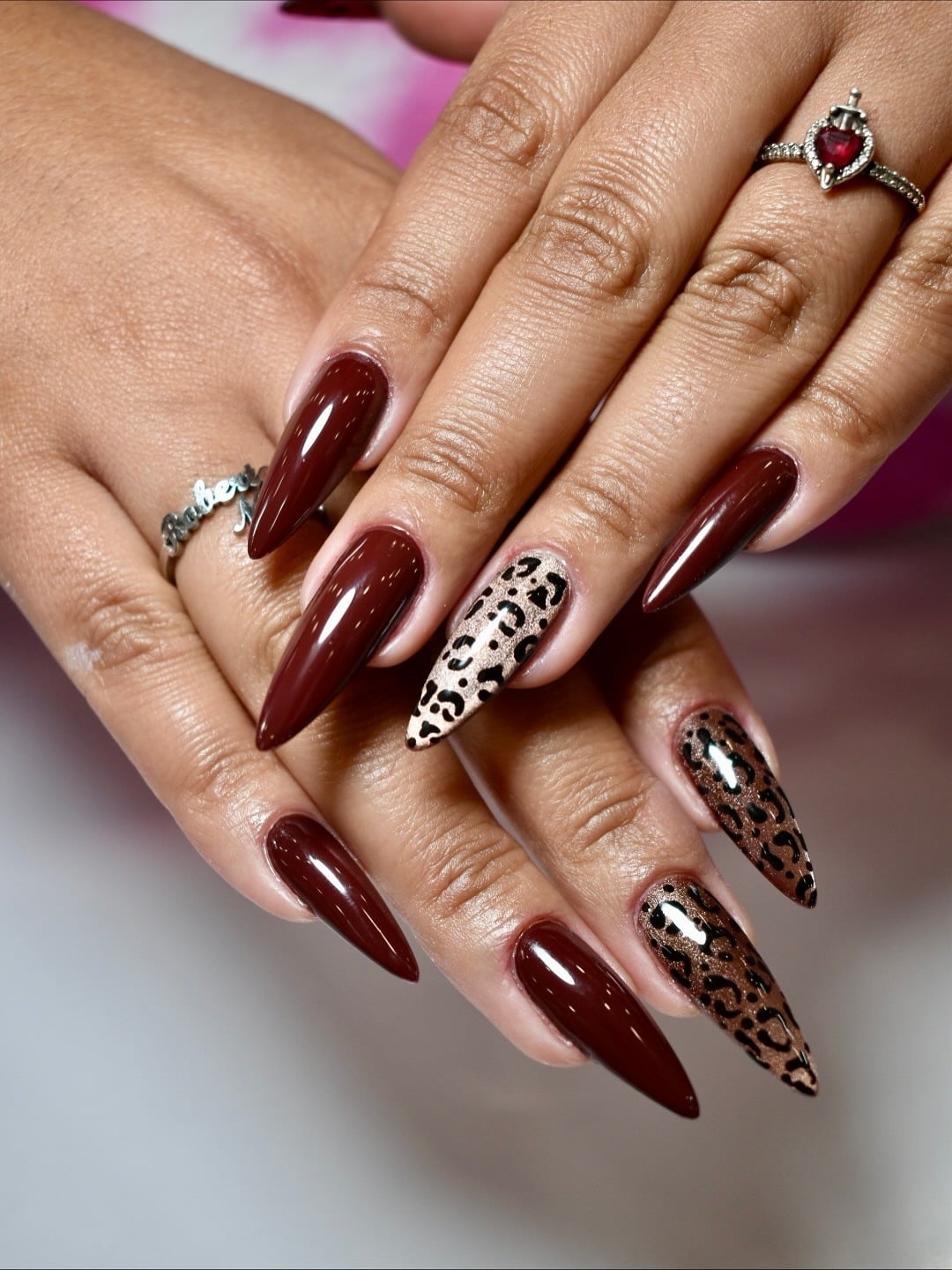 14. Burgundy Brown Almond Nails with Leopard Accent - brown almond nail ideas