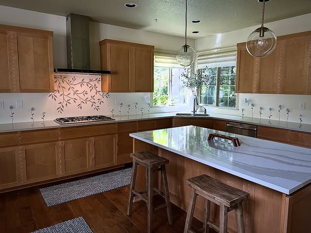 2. Warm Oak Cabinetry with Crisp White Waterfall Island - unique kitchen ideas