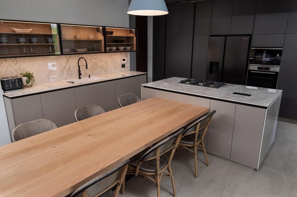 8. Contemporary Taupe Kitchen with Integrated Dining Table - unique kitchen ideas