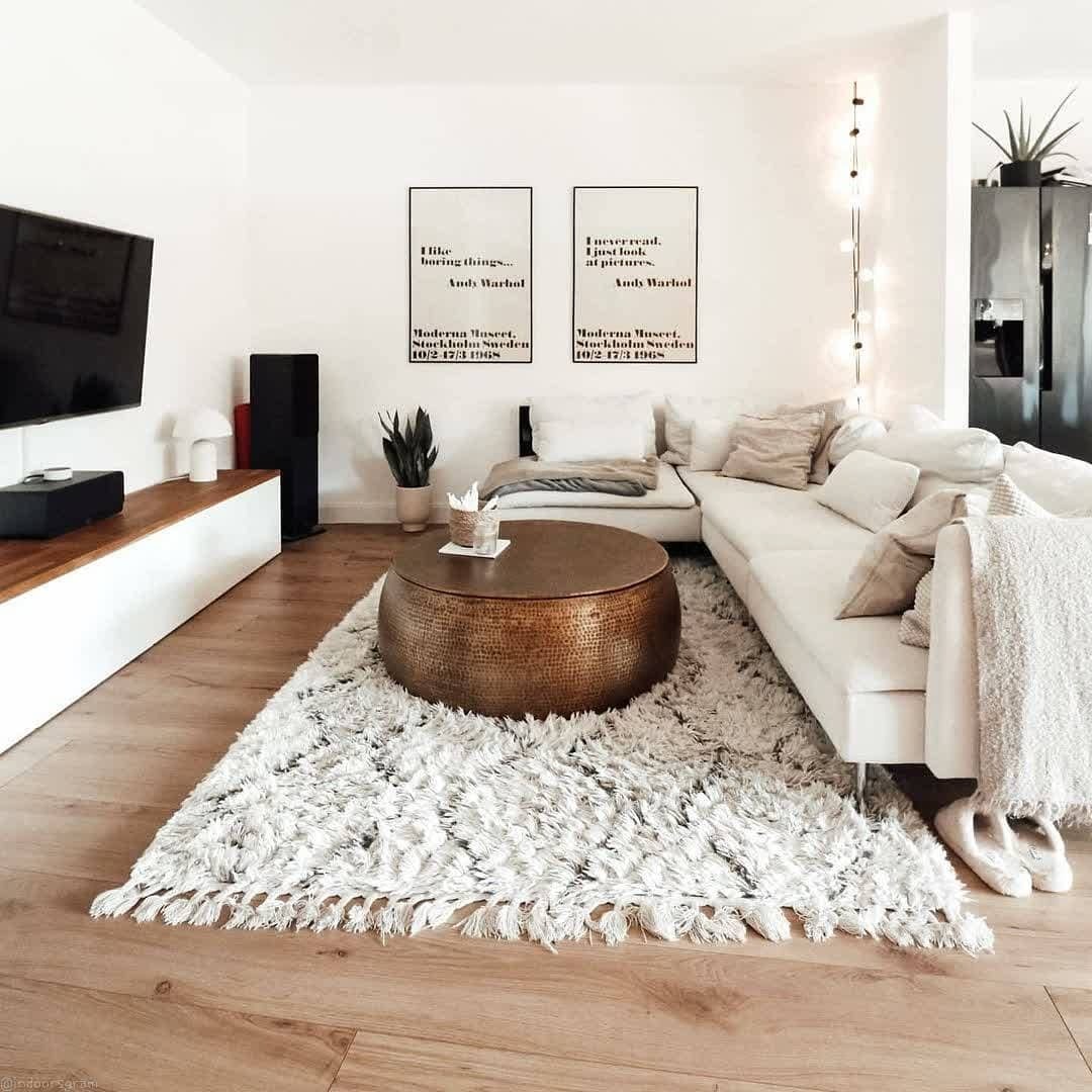 13. Contemporary White with Bronze Statement Table - white living room ideas