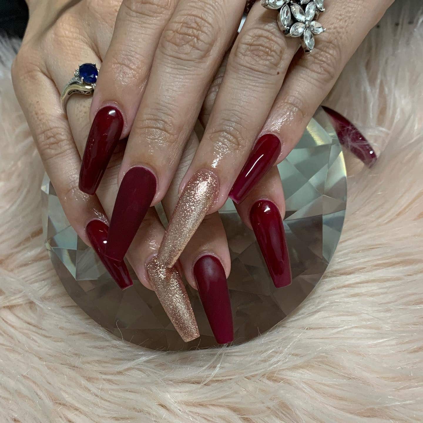 3. Glossy Burgundy and Gold Glitter Coffin Nails - burgundy and gold nail ideas