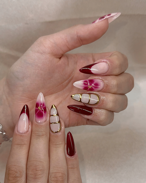 6. Burgundy Almond Nails with Pink Floral Art & Gold Foil - burgundy and gold nail ideas