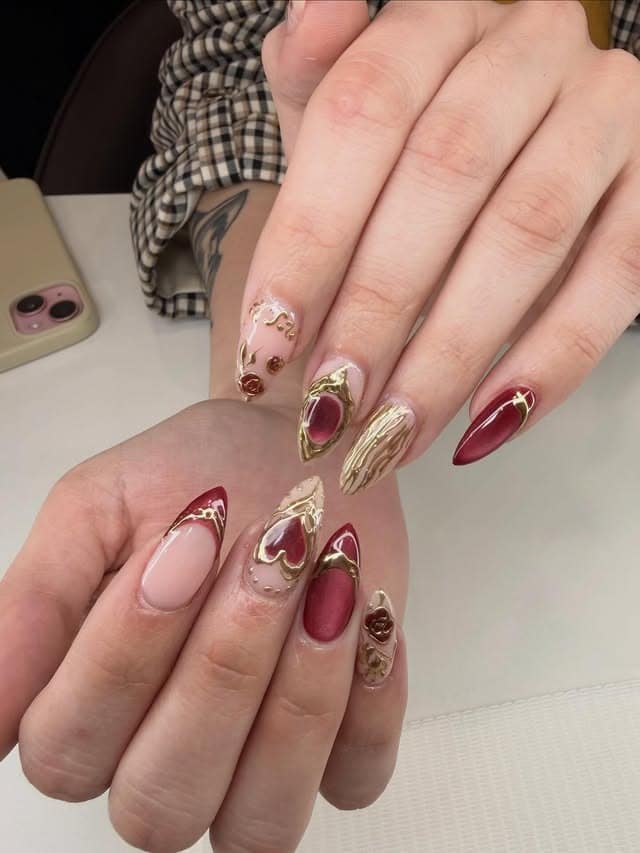9. Burgundy and Gold 3D Heart Accent Almond Nails - burgundy and gold nail ideas