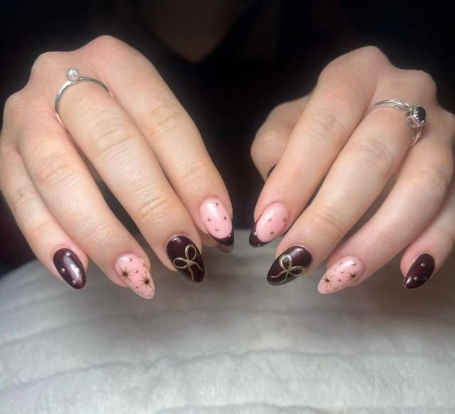 11. Burgundy and Blush Almond Nails with Gold Bow & Star Accents - burgundy and gold nail ideas