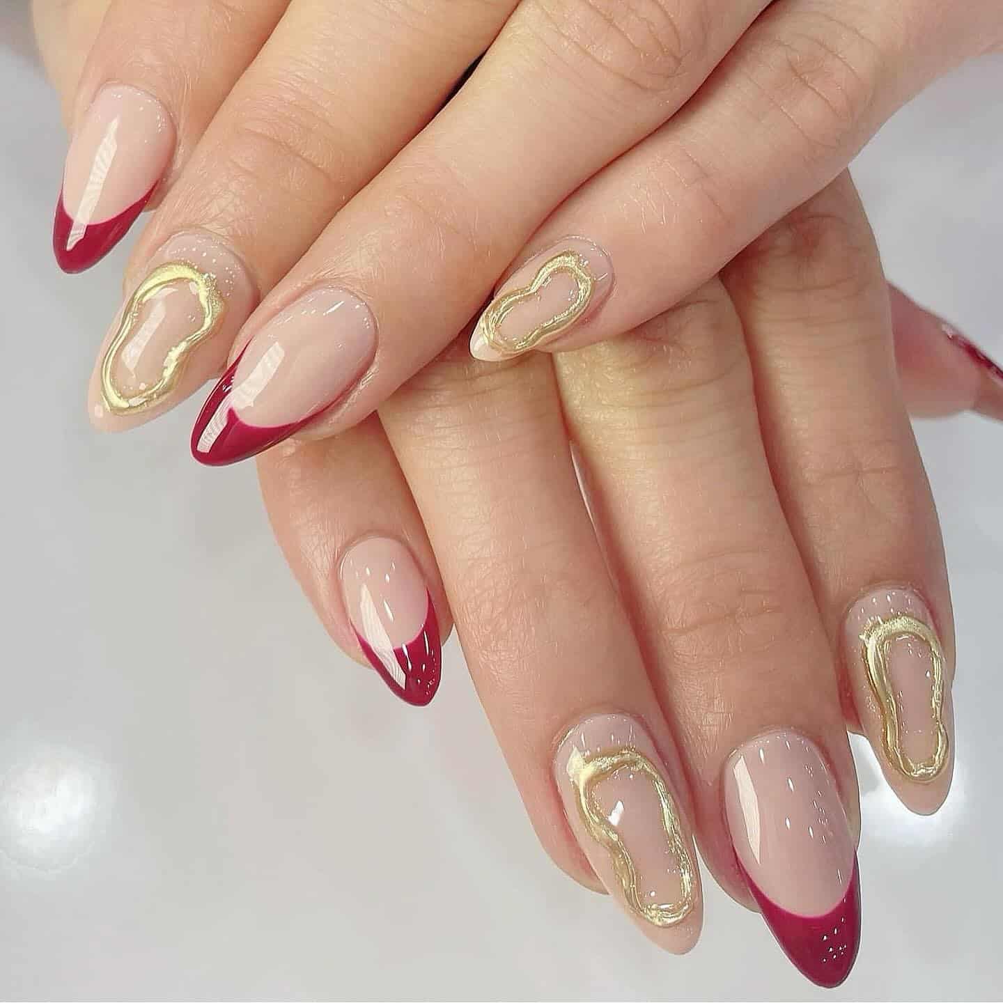 12. Burgundy French Almond Nails with Raised Gold Outline Art - burgundy and gold nail ideas