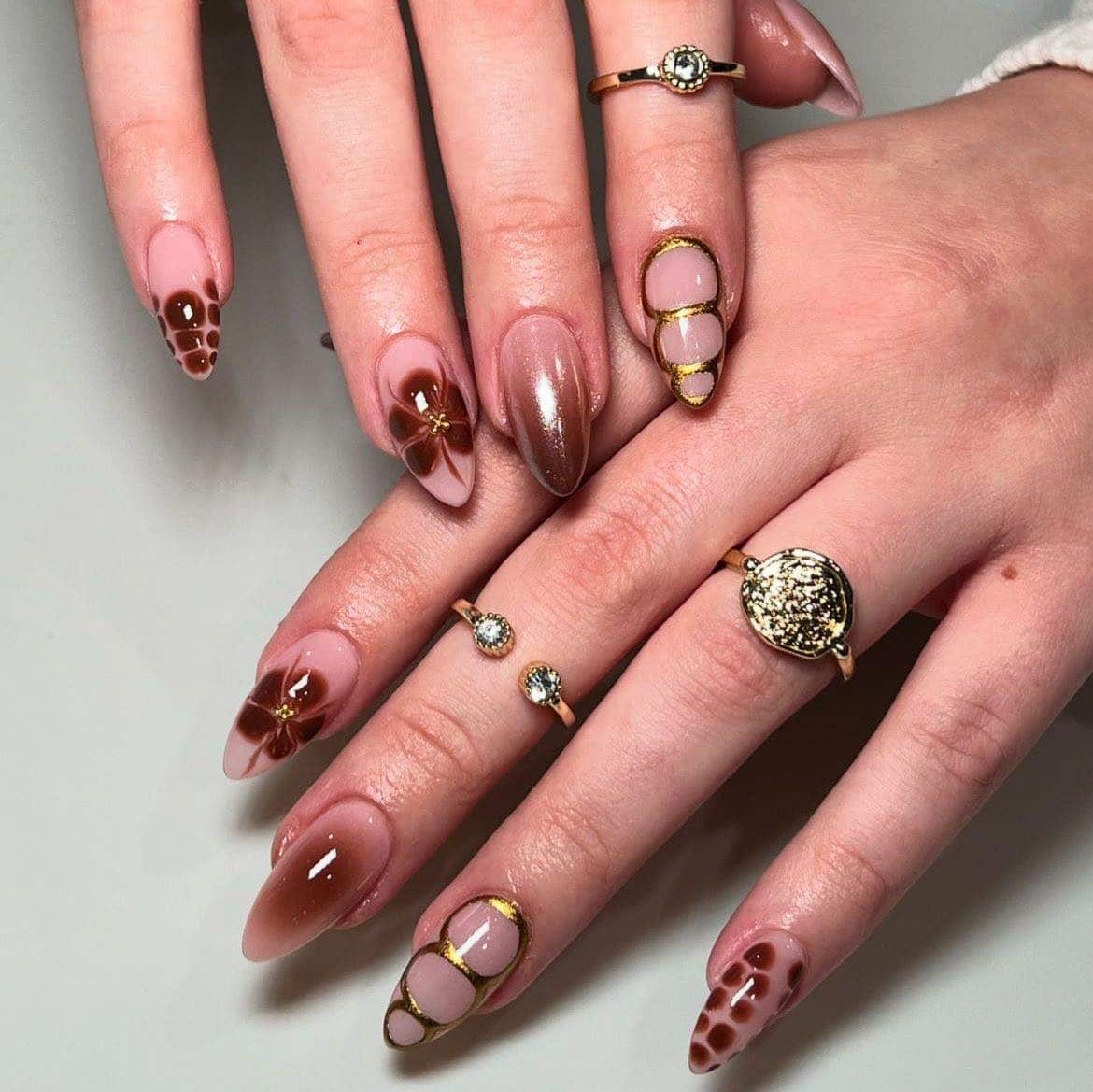 14. Mocha Burgundy Almond Nails with Gold Framing & Floral Art - burgundy and gold nail ideas