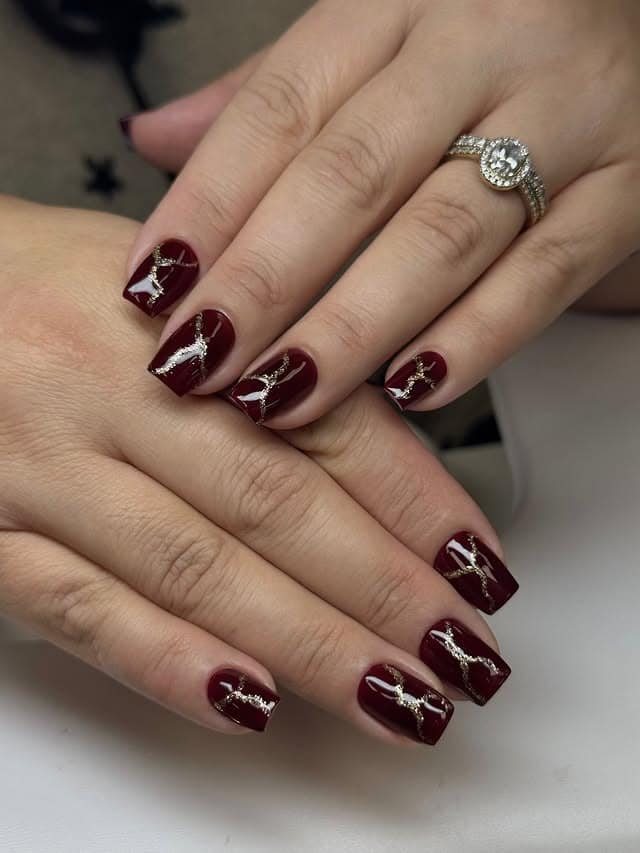 18. Glossy Burgundy Square Nails with Gold Ribbon Detailing - burgundy and gold nail ideas