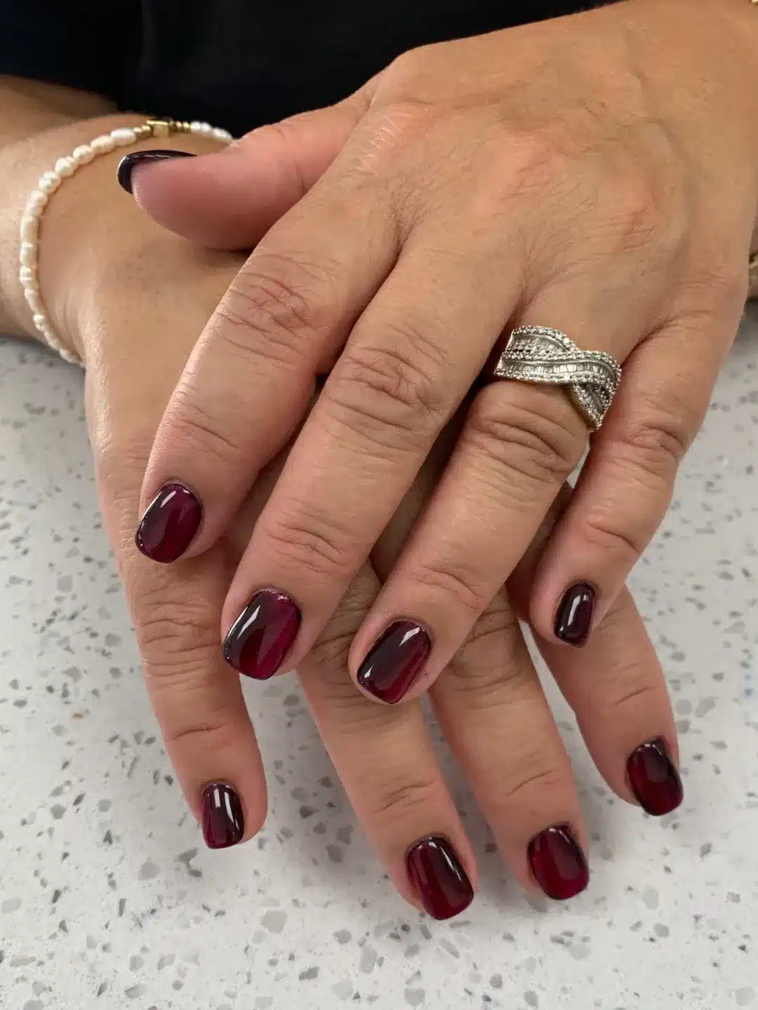 11. Glossy Burgundy Almond Nails with Abstract French Tips - burgundy fall nail ideas