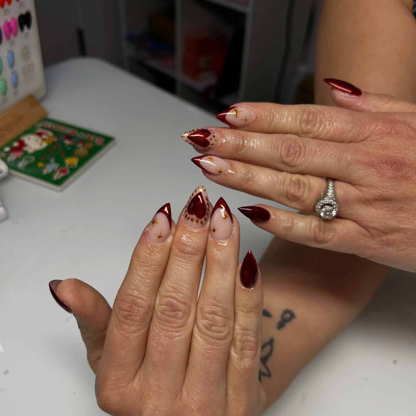 17. Burgundy French Stiletto Nails with Gold Details - burgundy fall nail ideas