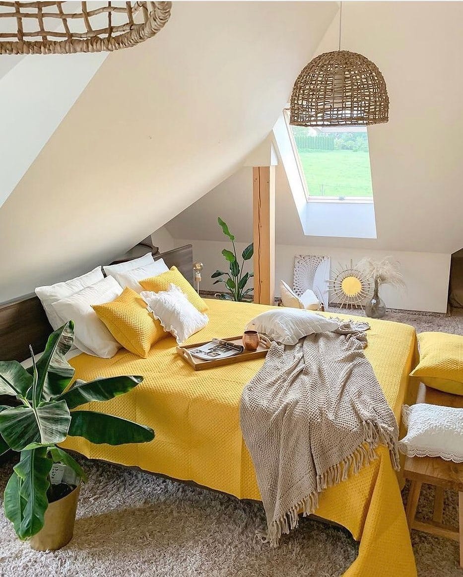 3. Cozy Attic Bedroom with Mustard Yellow Bedding - yellow bedroom ideas