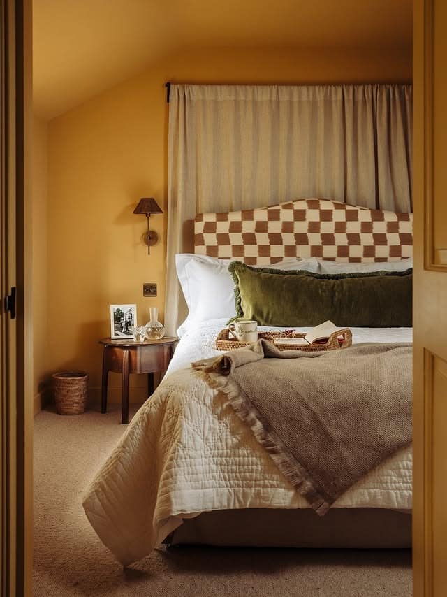 14. Moody Mustard Bedroom with Layered Textures - yellow bedroom ideas