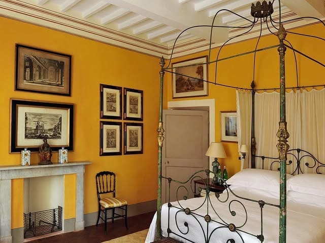 16. European-Inspired Bedroom in Rich Ochre Yellow - yellow bedroom ideas