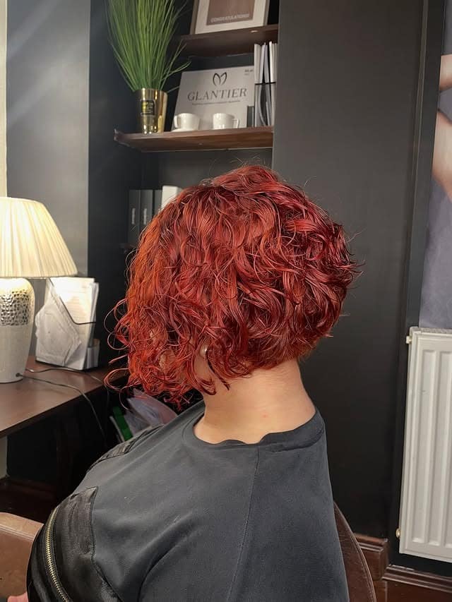 10. Deep Ruby Red Curly Bob with Voluminous Layers - Curly Bob Hairstyles