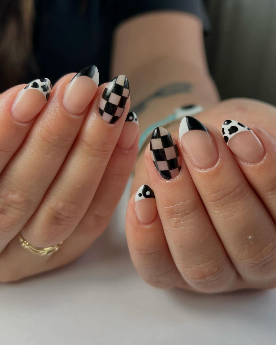 1. Monochrome Checkered French with Cow Print Accents - checkers nail ideas