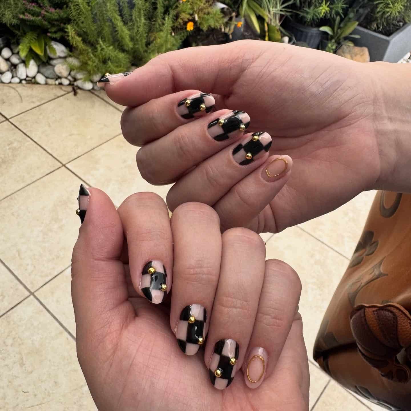 17. Black Checker with Gold Stud Accents - checkers nail ideas