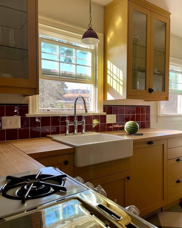 11. Mustard Shaker Kitchen with Burgundy Tile Backsplash - vintage kitchen ideas