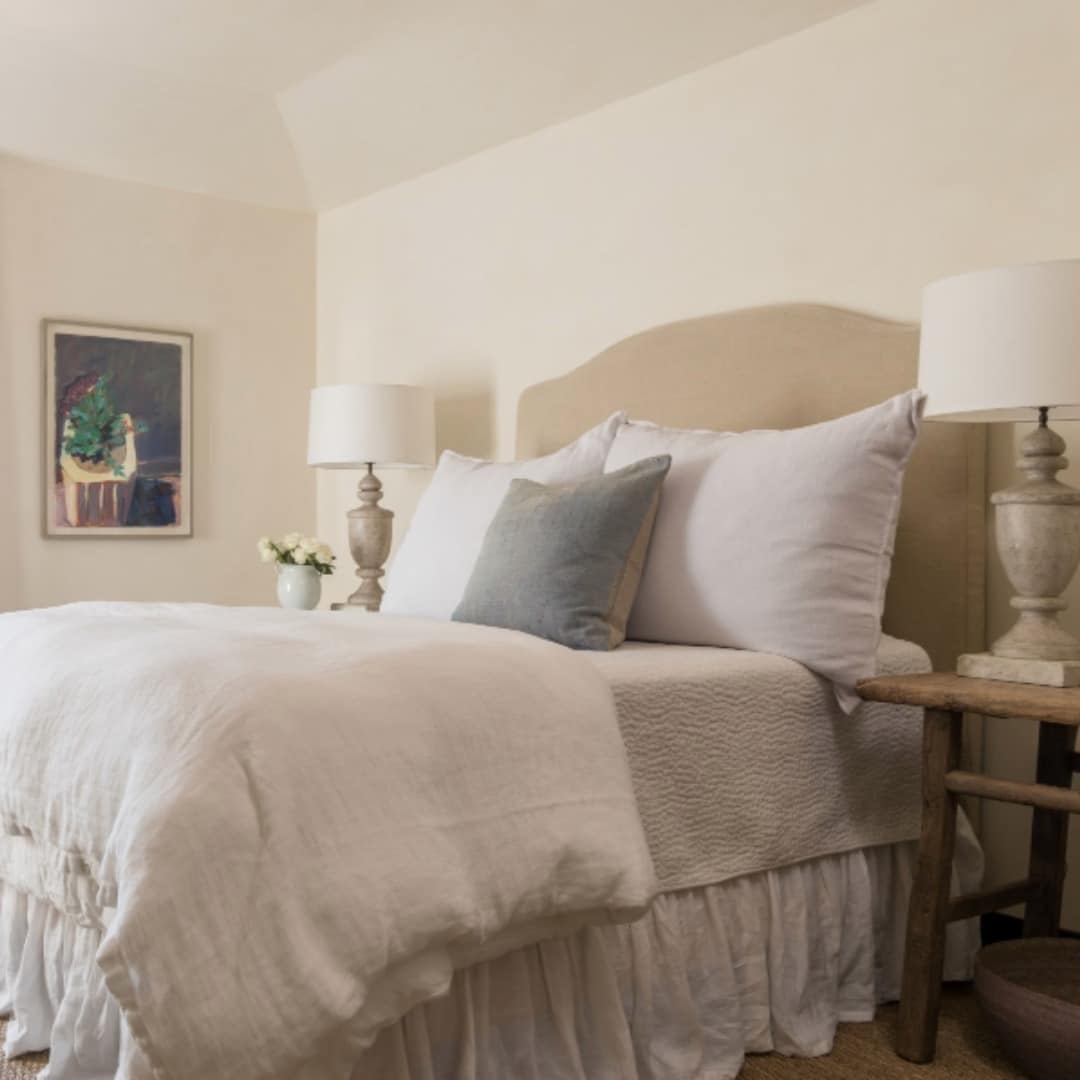 6. Classic Cream Bedroom with Subtle Blue Accent Pillow - off white bedroom ideas